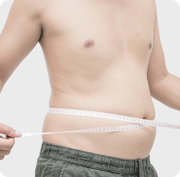 Overweight man measuring his stomach