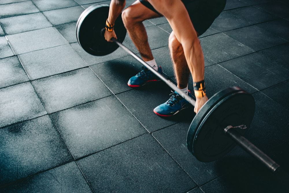 A man in the gym trying to lift weight