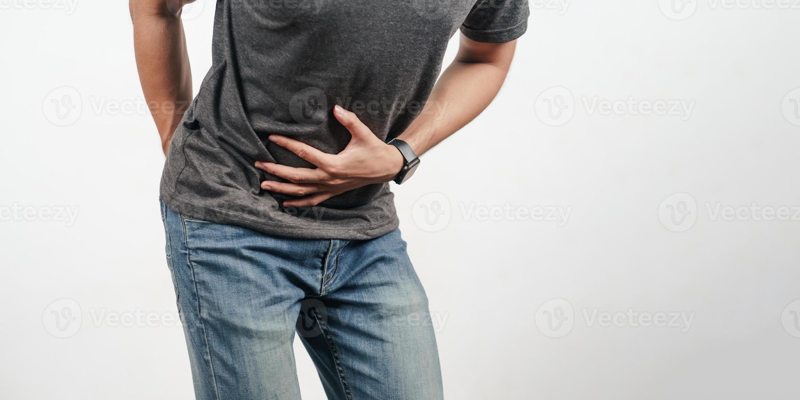 A man holding his stomach due to stomach ache